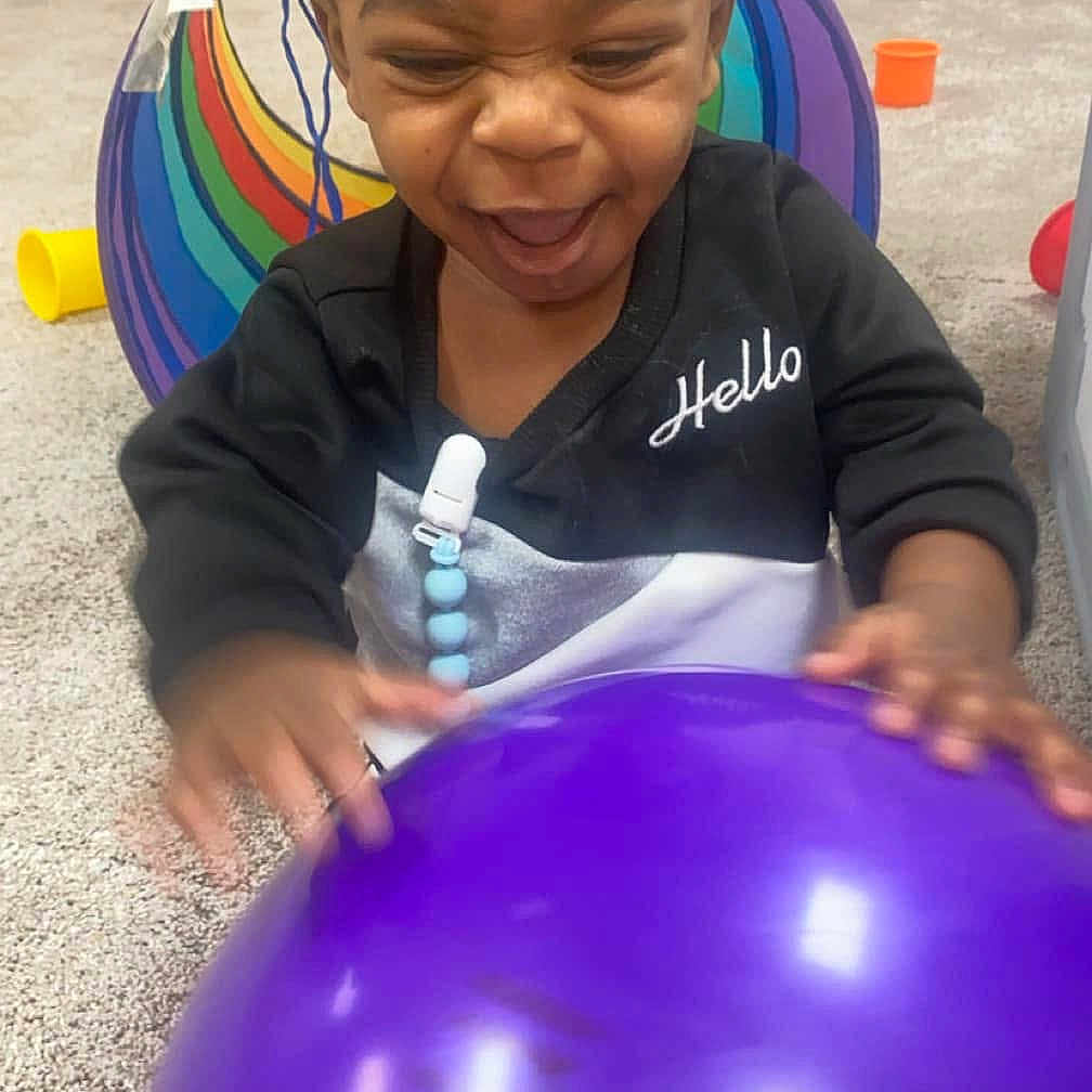 Legend is registered to the contest to win money with this photo: astronomy, baby, babylaughing, ball, balloon, face, football, happy, head, indoors, moon, nature, night, person, photography, portrait, purple, soccer, soccerball, sport