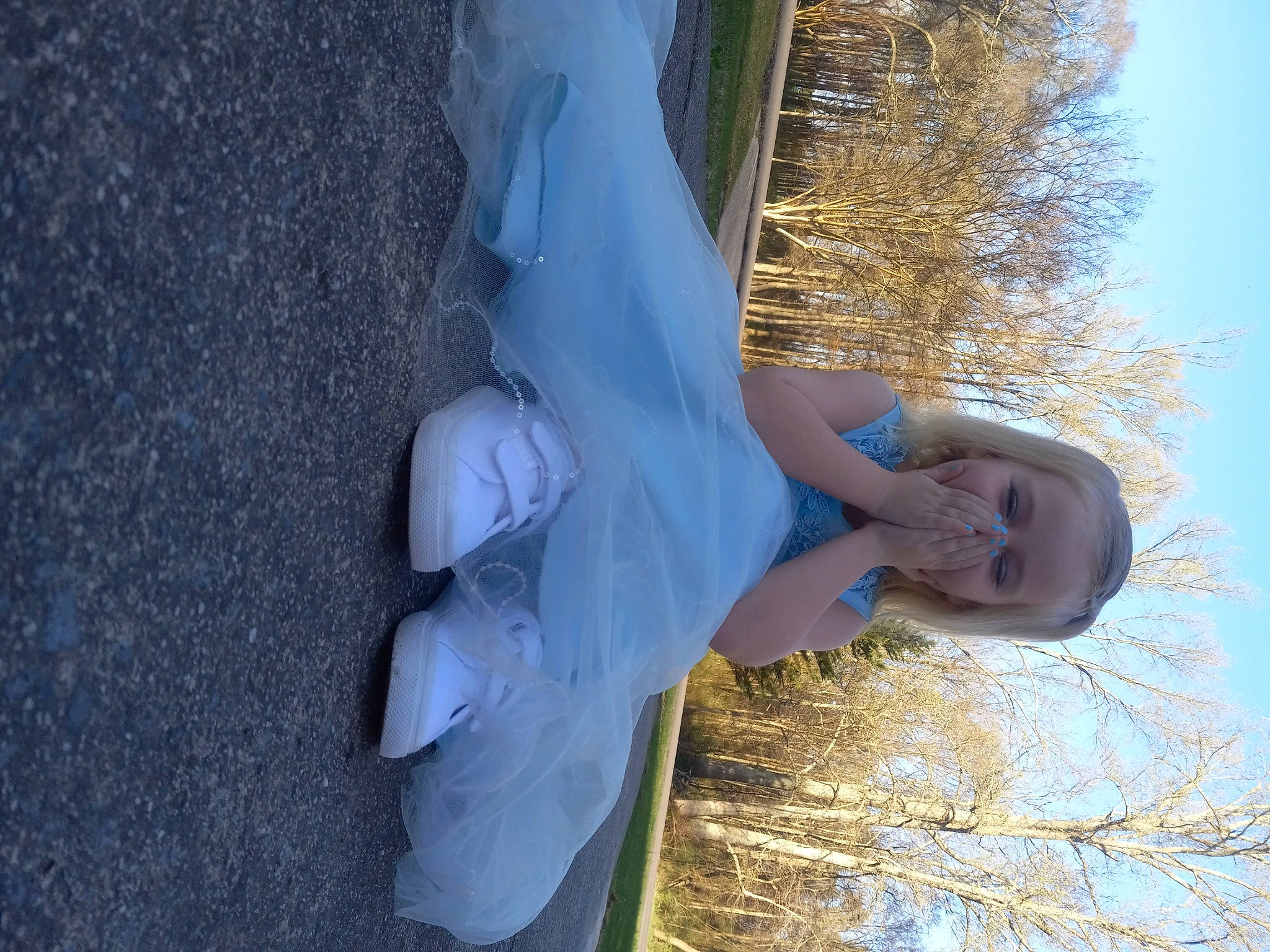 Emma is registered to the contest to win money with this photo: arm, azure, dress, elbow, electric_blue, freezing, fun, gesture, happy, human_leg, leisure, people_in_nature, person, plant, sky, tree, trunk, twig, water, winter