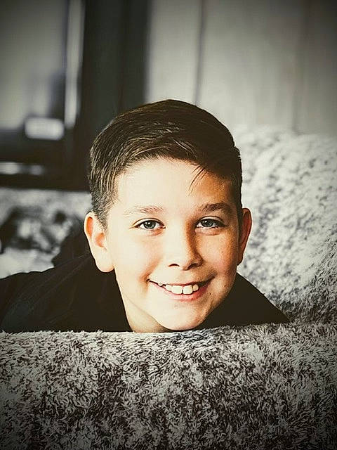 Triston is registered to the contest to win money with this photo: black_and_white, black_hair, cheek, child, eye, face, flash_photography, fun, happy, jaw, joy, laugh, lip, monochrome, monochrome_photography, nose, person, portrait, portrait_photography, sitting