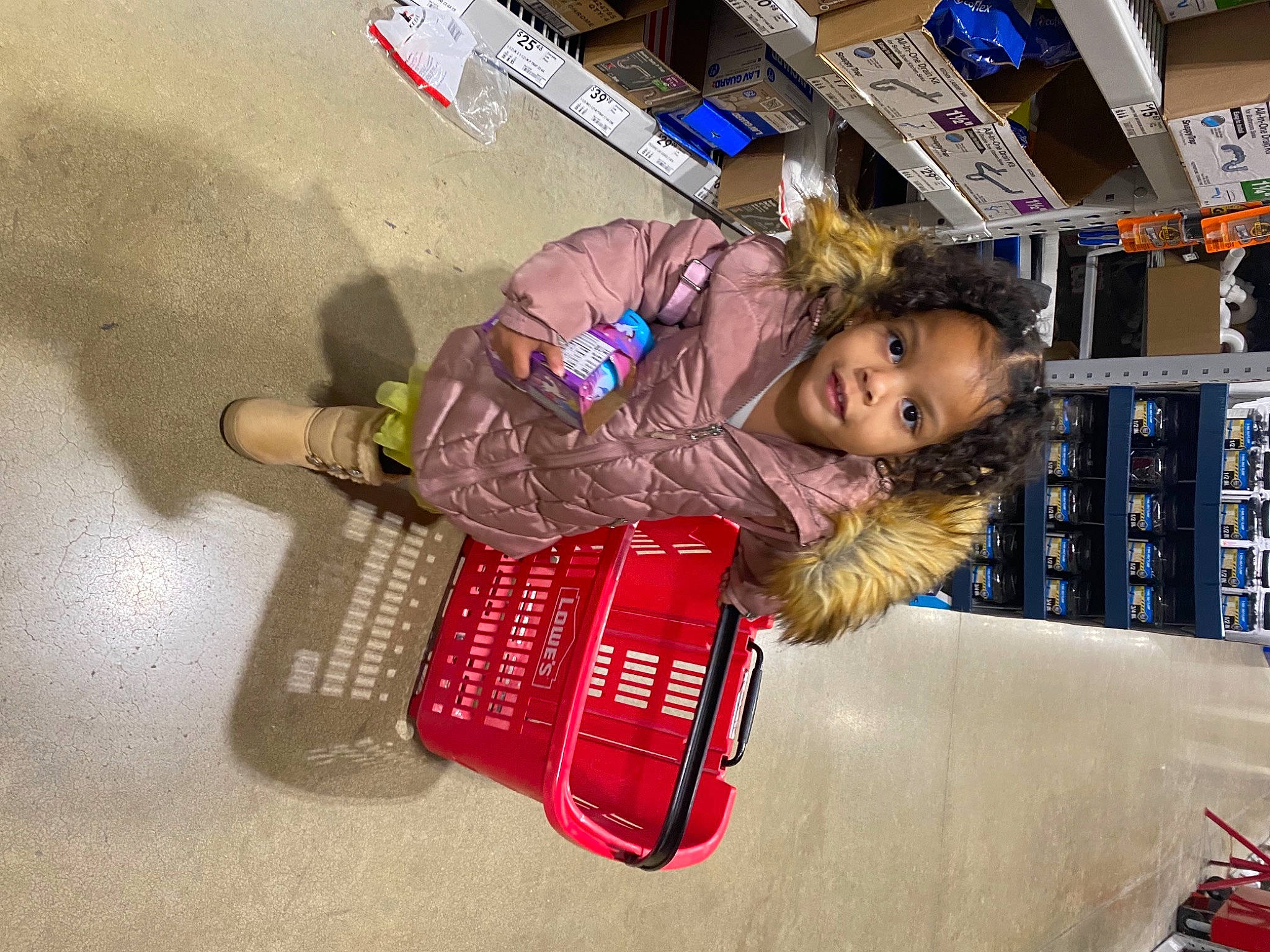 Ulani is registered to the contest to win money with this photo: baby_toddler_clothing, building, child, flooring, fun, person, play, retail, shelf, sitting, smile, toddler