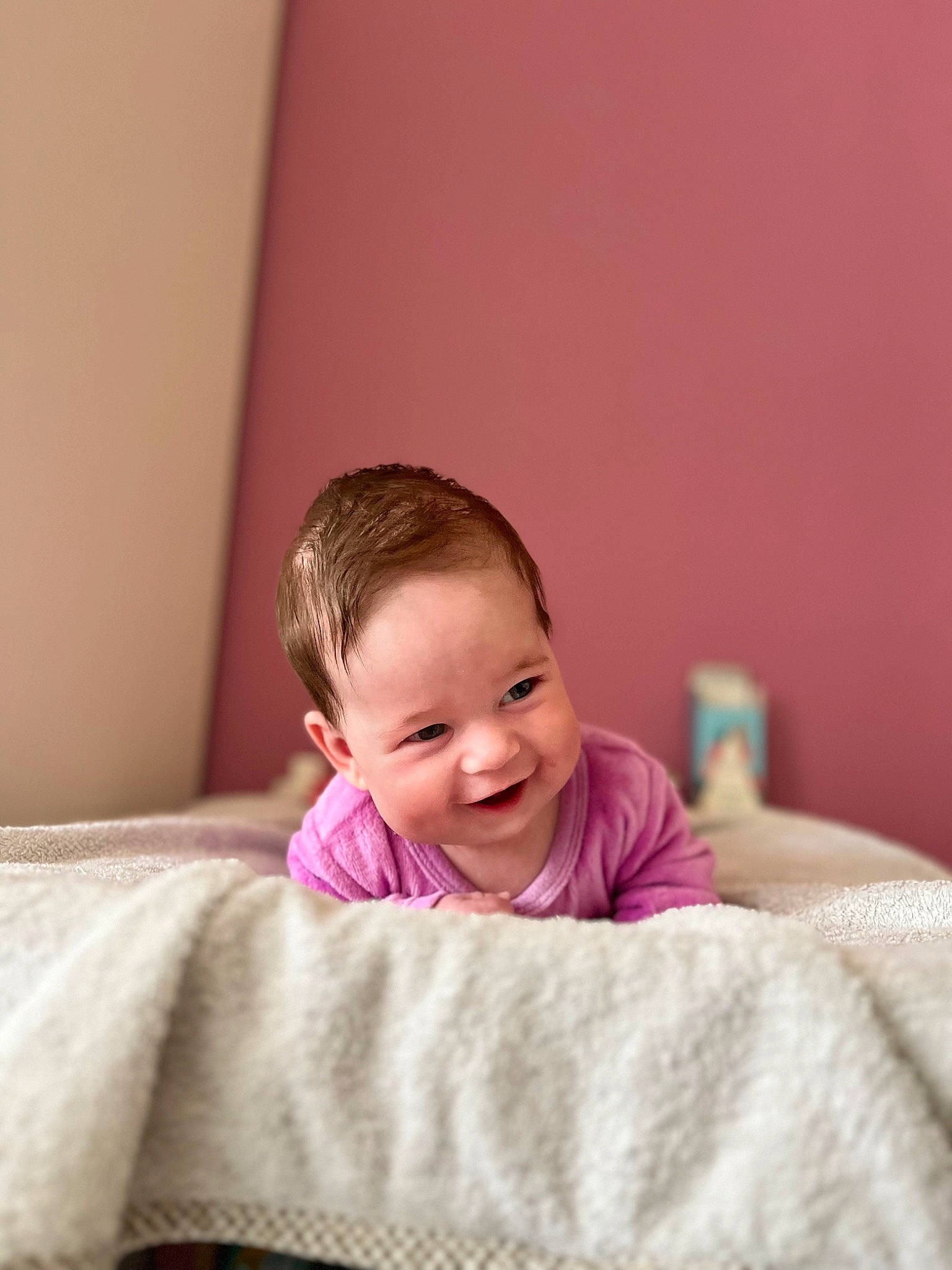 Alessia participe au concours pour gagner de l'argent avec cette photo : baby, baby_toddler_clothing, bedding, cheek, child, comfort, eye, face, flash_photography, flooring, happy, joy, linens, magenta, nose, person, pink, room, sitting, skin
