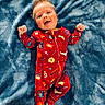 Henry joined the competition — help win amazing prizes! baby, infant, smiling, lying_down, red_onesie, harry_potter_theme, blue_blanket, soft_texture, happy, face, child, cute, portrait, young_child, cozy, indoors, clothing, person, head, expression