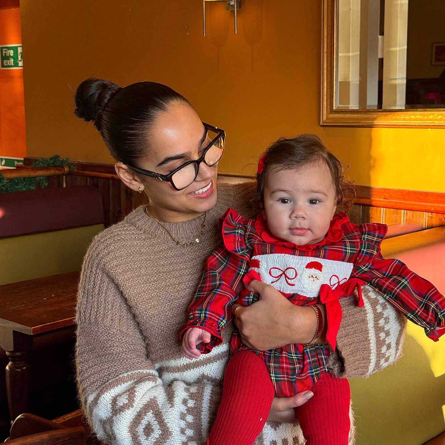 Alina Luellè joined the competition — help win amazing prizes! baby, bench, casual_clothing, child, cozy, family, glasses, happy, holding, indoor, mirror, person, plaid_dress, red_tights, smiling, sweater, wall_lamp, warm_lighting, woman, wooden_table