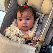 Alina Luellè joined the competition — help win amazing prizes! baby, stroller, blanket, wooden_toy, hair_clip, infant, child, seat, fabric, cute, indoor, clothing, comfort, person, face, expression, soft, pink, accessory, closeup