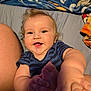 Charles joined the competition — help win amazing prizes! baby, child, smiling, blue_onesie, blanket, bed, person, happy, infant, cute, skin, hand, foot, lying_down, indoor, cozy, portrait, young_child, playful, expression
