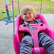 Charles joined the competition — help win amazing prizes! toddler, child, swing, pink_swing, smiling, outdoor, backyard, grass, bicycle, basketball_hoop, toys, concrete, clothing, happy, person, play, rope, seat, daylight, young_child