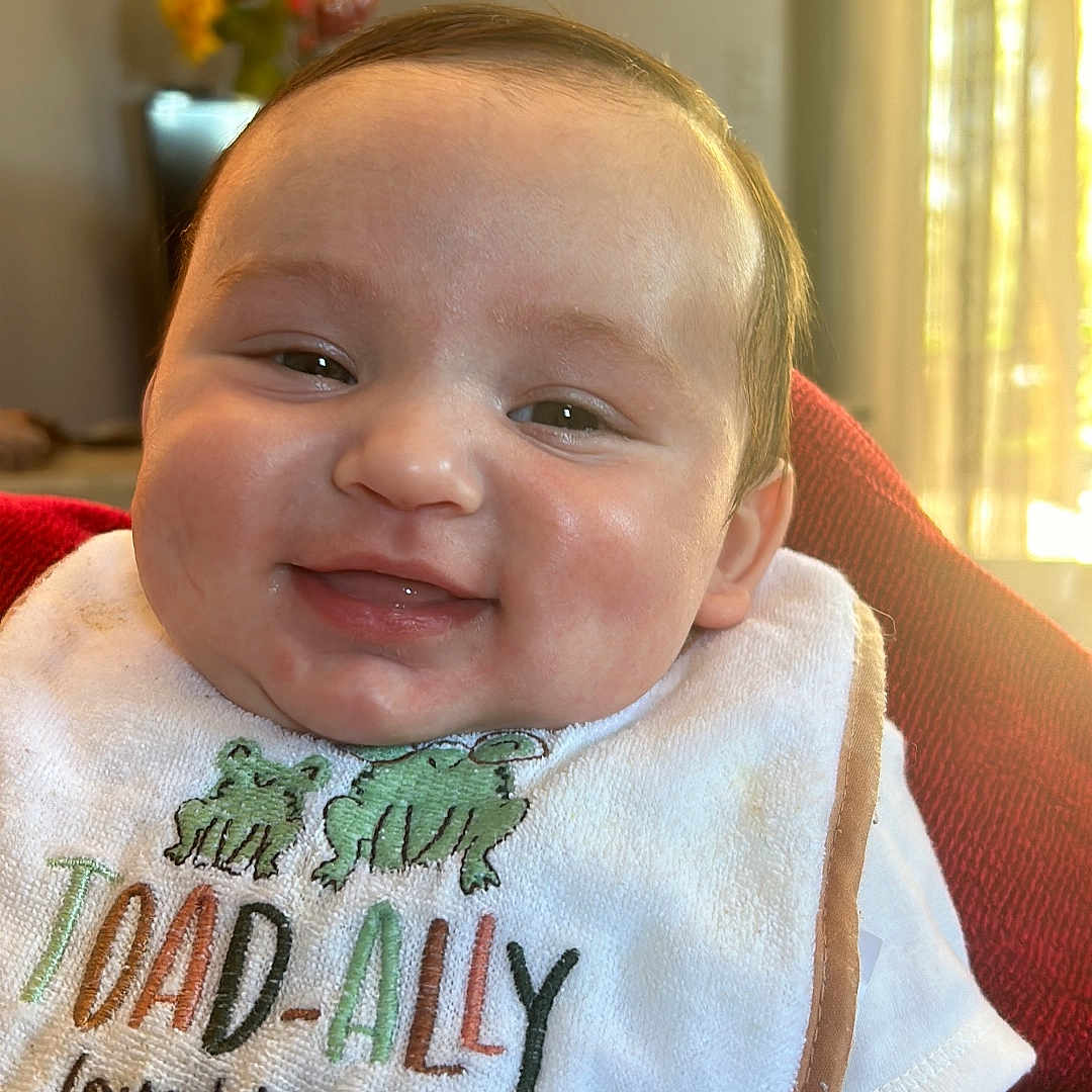 Jayliel is registered to the contest to win money with this photo: applique, baby, bib, cushion, embroidery, face, flower, head, homedecor, newborn, pattern, person, photography, plant, portrait, stitch