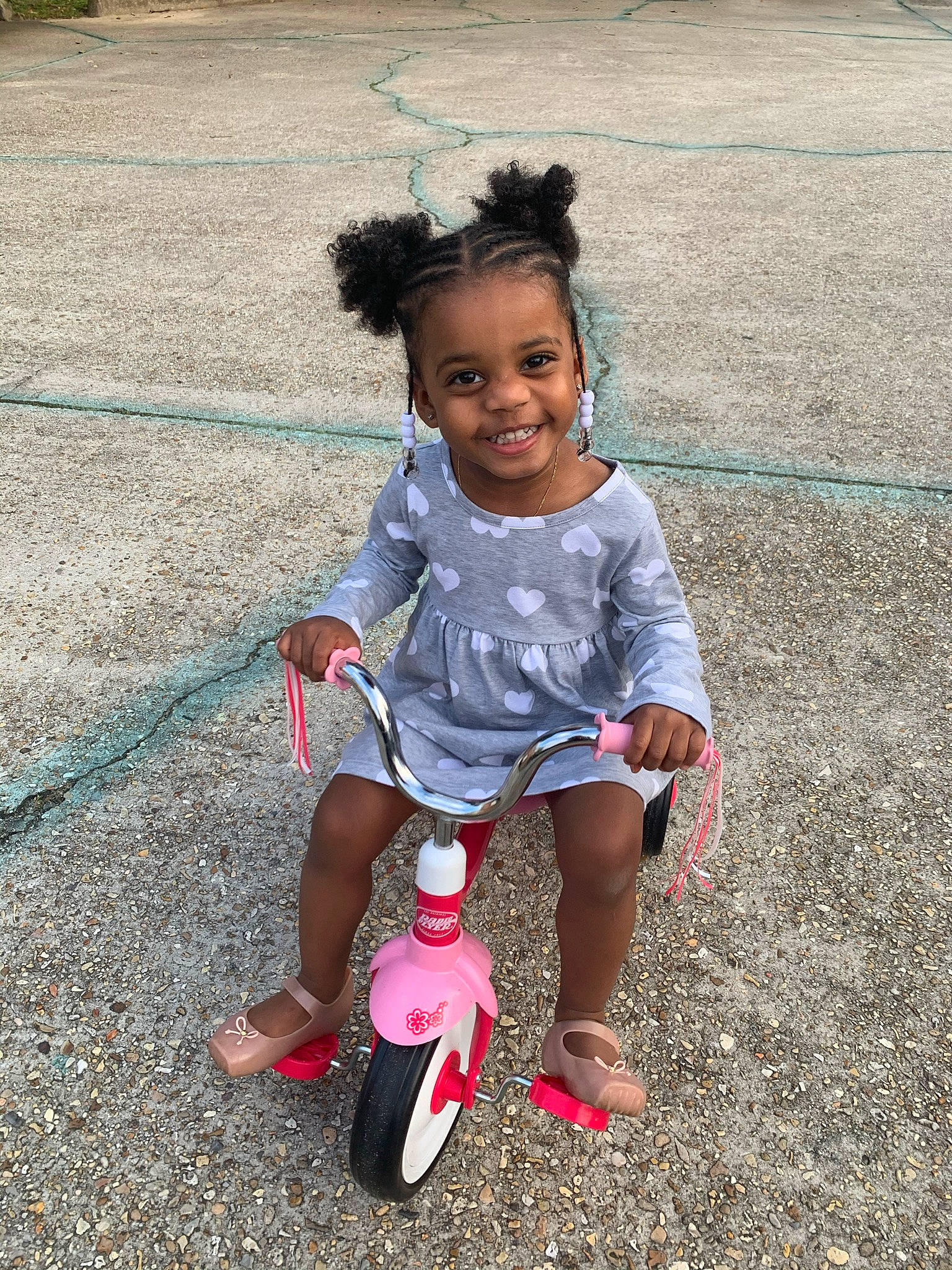 Nova Rae is registered to the contest to win money with this photo: automotive_tire, baby_toddler_clothing, child, dress, footwear, fun, grass, happy, joy, leg, leisure, magenta, person, pink, plant, recreation, sandal, smile, summer, tire