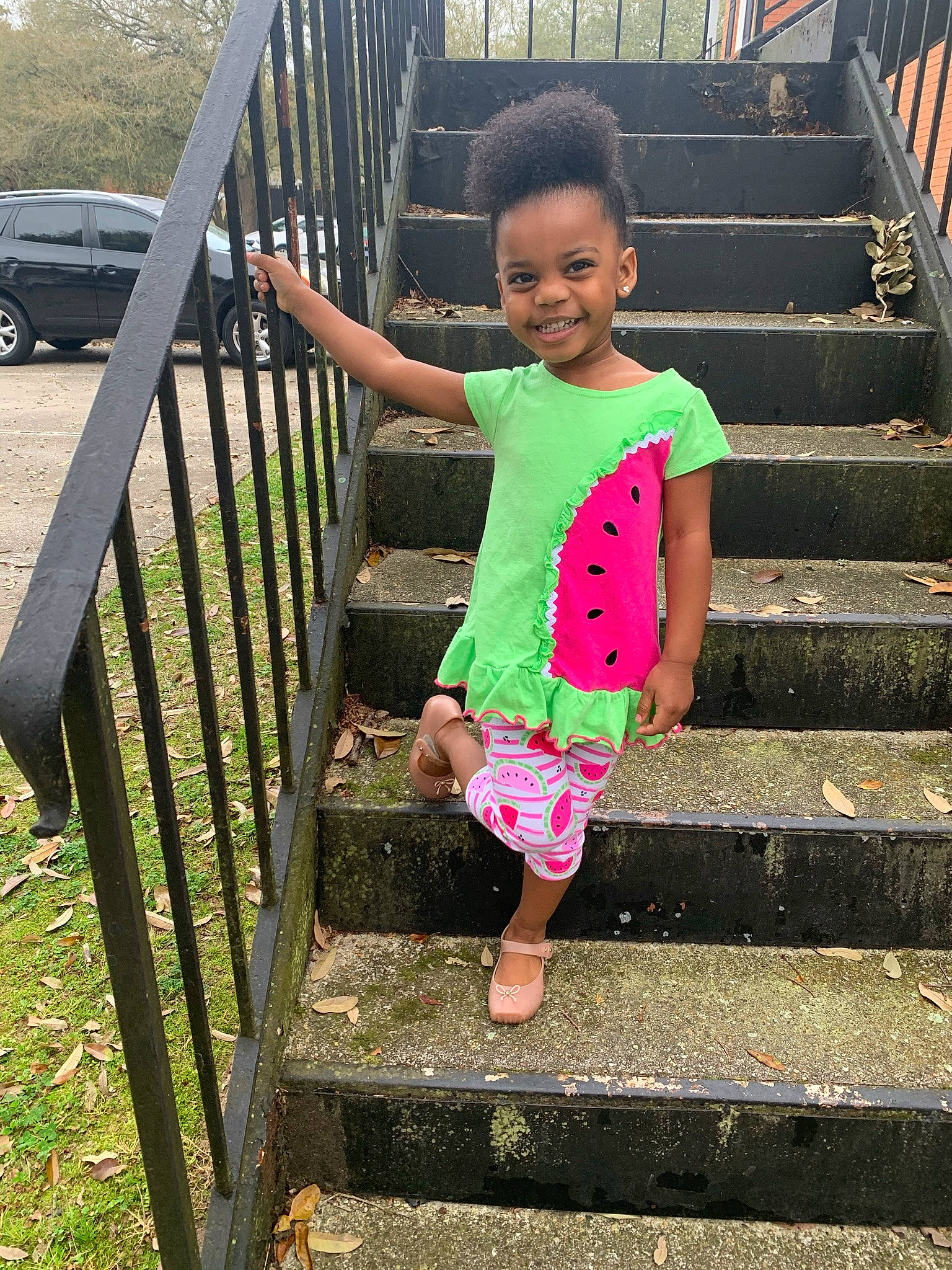 Nova Rae is registered to the contest to win money with this photo: baby_toddler_clothing, child, grass, happy, human_body, joy, leg, leisure, line, magenta, person, public_space, shorts, sleeve, smile, standing, t_shirt, tire, toddler, tree