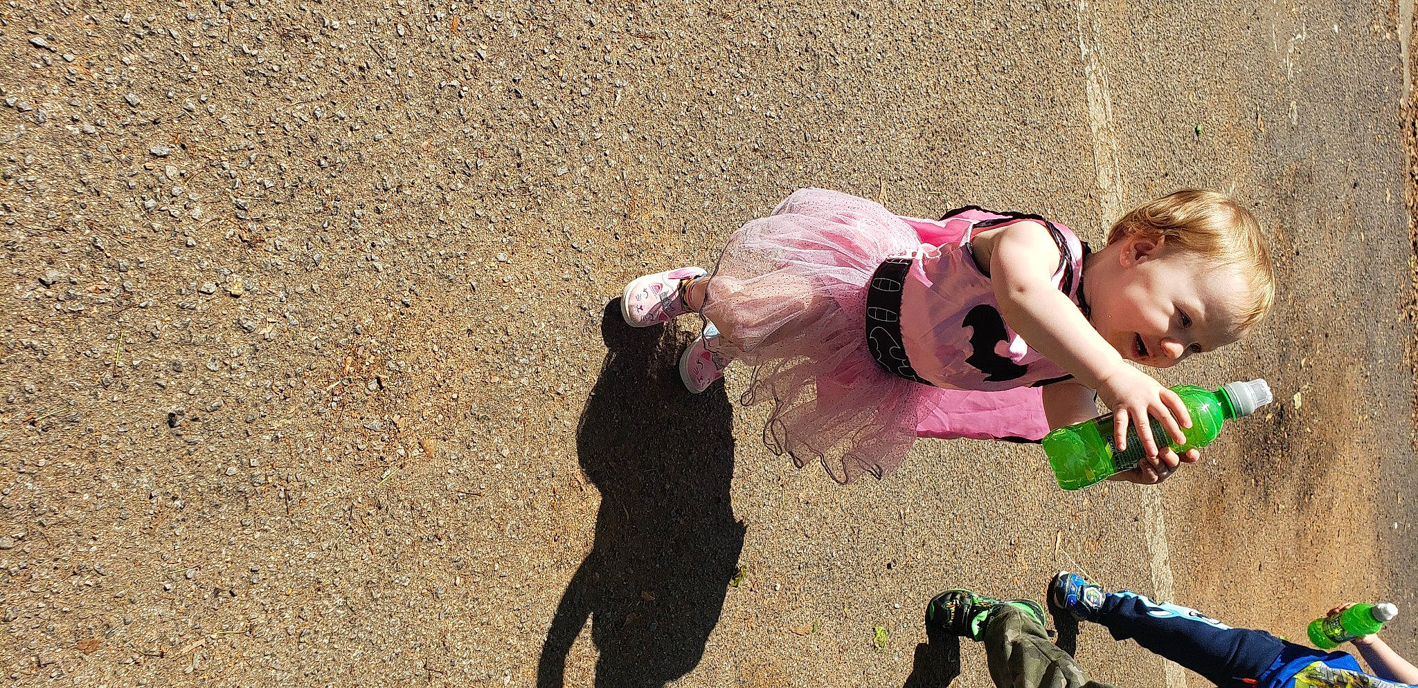 Madison joined the competition — help win amazing prizes! asphalt, boot, child, costume, eyewear, fun, grass, happy, human_leg, leisure, magenta, people_in_nature, person, recreation, sand, shadow, sitting, soil, sunglasses, thigh
