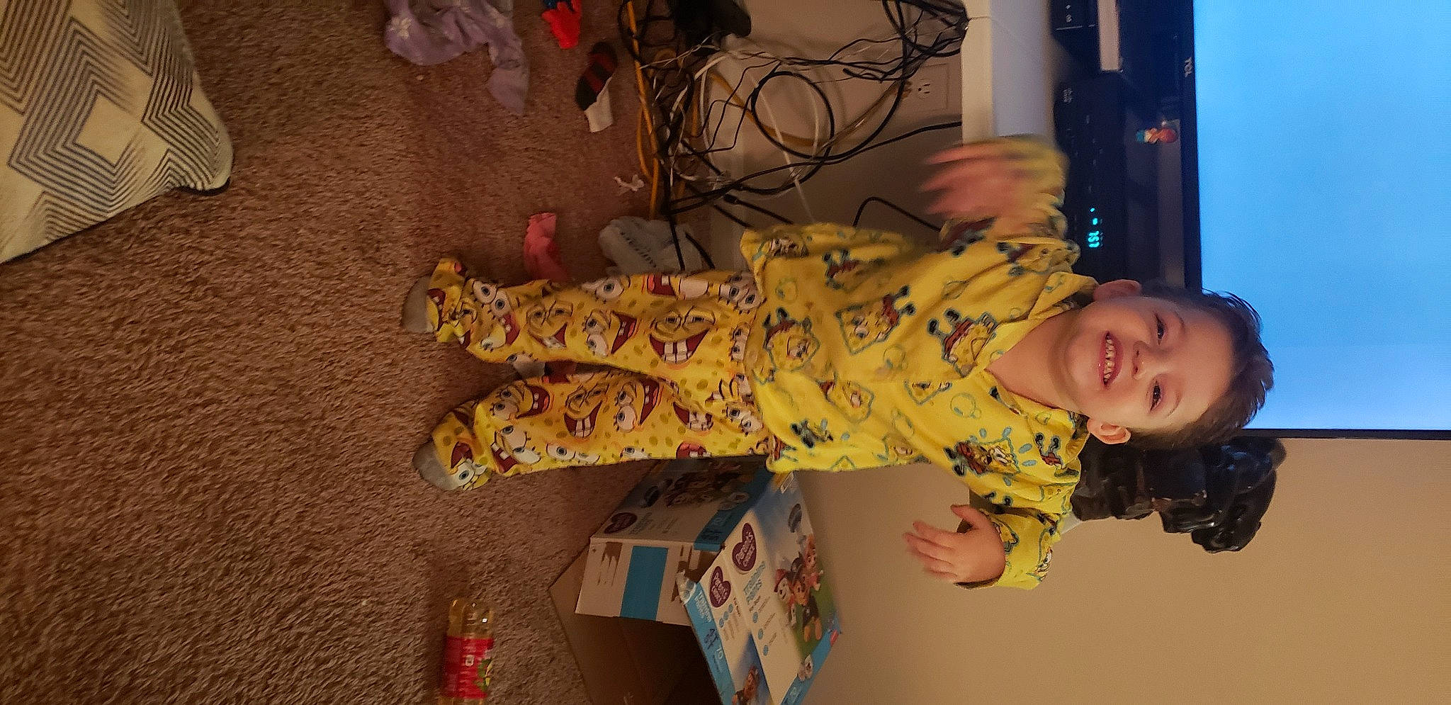 Charles is registered to the contest to win money with this photo: baby, box, child, flooring, fun, fur, human_leg, joy, military_camouflage, pattern, person, room, smile, thigh, toddler, visual_arts, wood