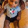 Dekhari joined the competition — help win amazing prizes! toddler, child, red_cap, chain, sneakers, sitting, chair, gray_shirt, black_shorts, indoor, cute, fashion, footwear, person, baby, portrait, smiling, cozy, casual, home