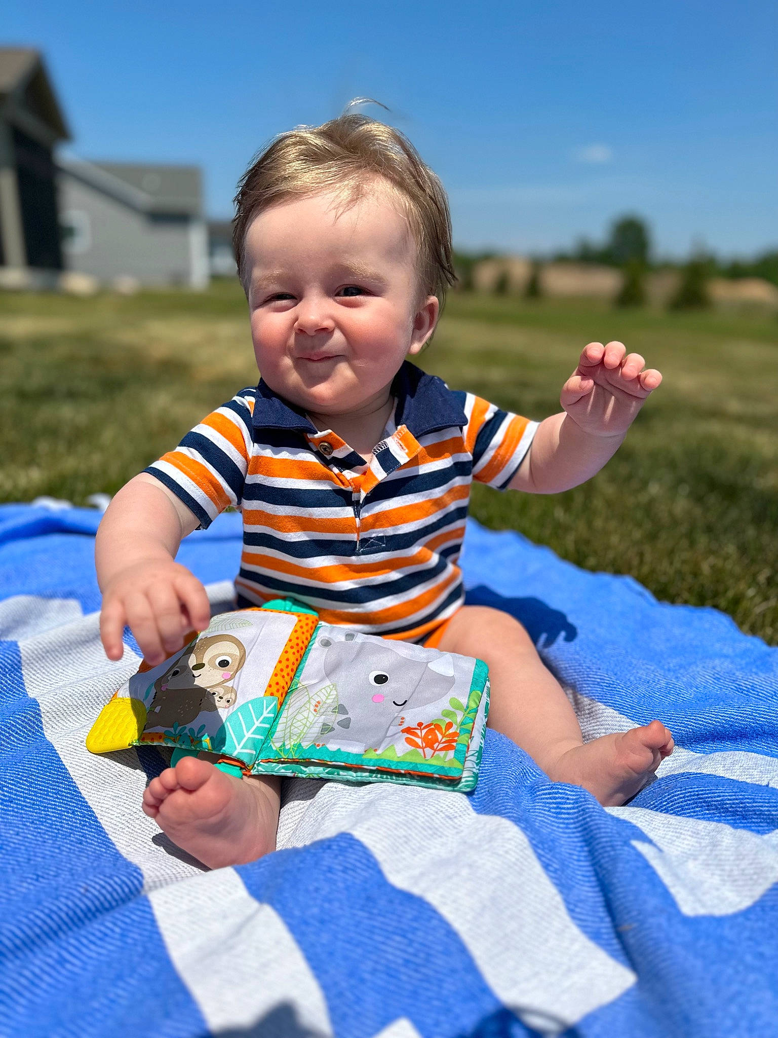 Preston is registered to the contest to win money with this photo: baby, baby_toddler_clothing, blue, child, event, fun, grass, happy, leisure, pattern, person, plant, play, recreation, sitting, sky, sleeve, smile, t_shirt, toddler