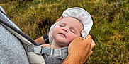 Mila joined the competition — help win amazing prizes! baby, sleeping, carrier, adult, hat, outdoor, grass, field, clouds, nature, person, portrait, closeup, hand, face, resting, parent, holding, summer, relaxation