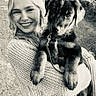 animal, black_and_white, cute, daylight, dog, forest, friendly, happy, holding, leash, nature, outdoor, path, pet, portrait, puppy, smile, sweater, woman, young_adult
