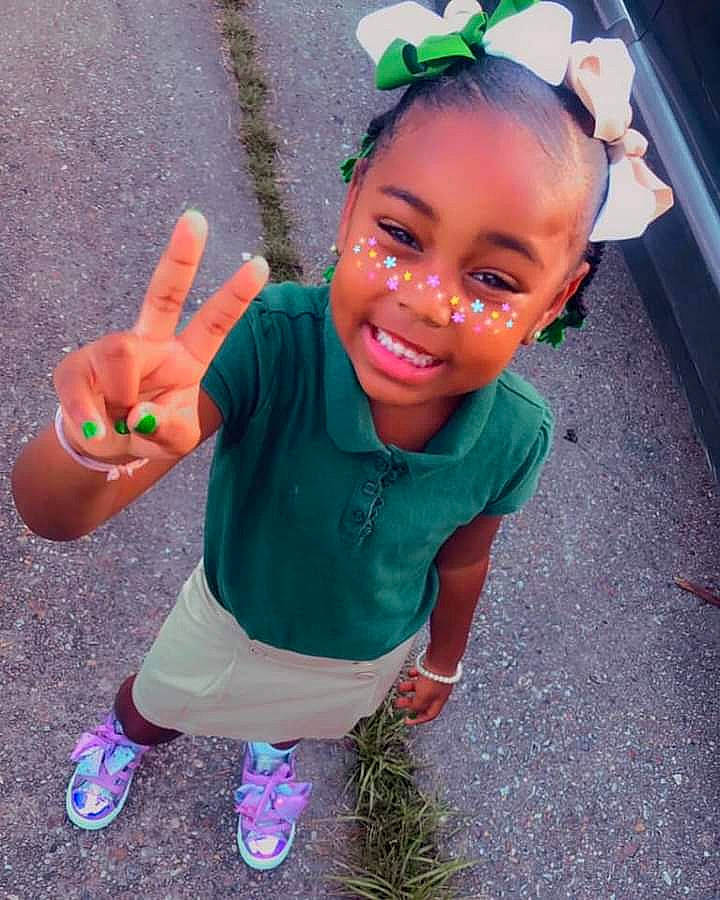 Lyric is registered to the contest to win money with this photo: arm, baby_toddler_clothing, beauty, child, cool, face, facial_expression, fun, gesture, grass, happy, head, joy, person, pink, skin, sleeve, smile, summer, thumb