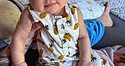 Riella joined the competition — help win amazing prizes! baby, infant, child, person, headband, pineapple_pattern, clothing, bedroom, blanket, hand, face, blue_eyes, tattoo, sitting, comfort, indoor, furniture, door, foot, casual
