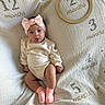 baby, infant, child, headband, pink_bow, socks, milestone_blanket, months, tongue_out, cute, smile, sitting, clothing, soft_texture, fabric, portrait, indoor, light, person, happy