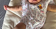Riella joined the competition — help win amazing prizes! arms_spread, baby, cheeky, child, comfort, cushion, cute, face, floral_pattern, happy, indoor, infant, lying_down, onesie, person, plush, smiling, sock, soft_texture, winnie_the_pooh