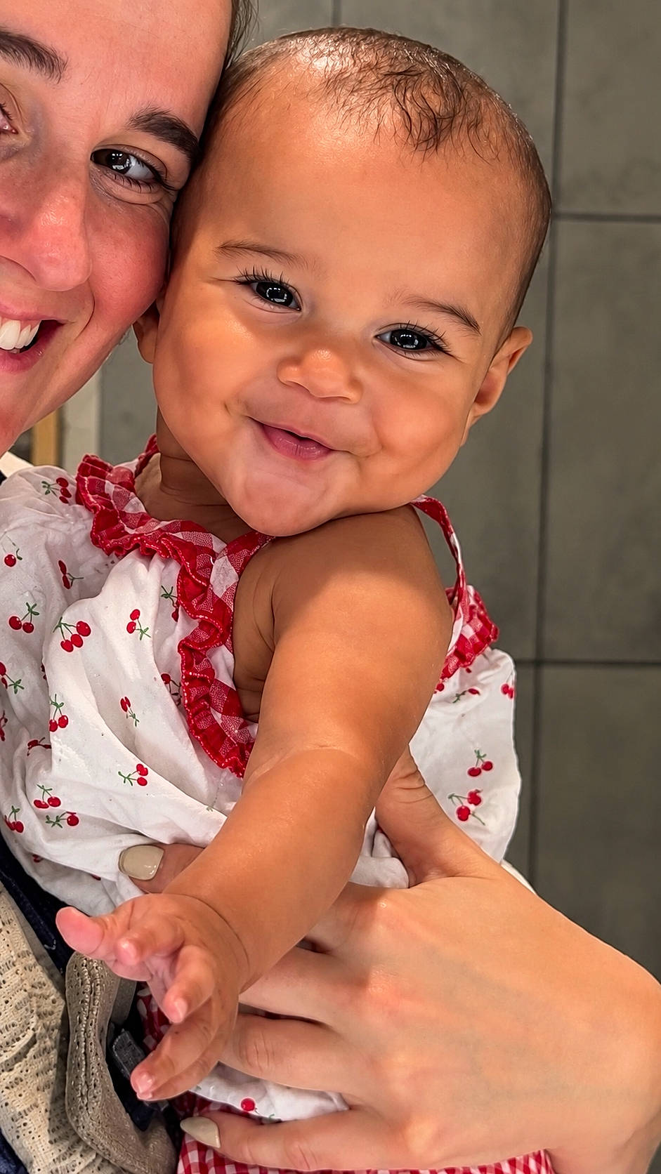 Layla is registered to the contest to win money with this photo: adult, baby, cherry, child, closeup, clothing, cute, face, hand, happy, holding, indoor, love, pattern, person, portrait, red, skin, smiling, white