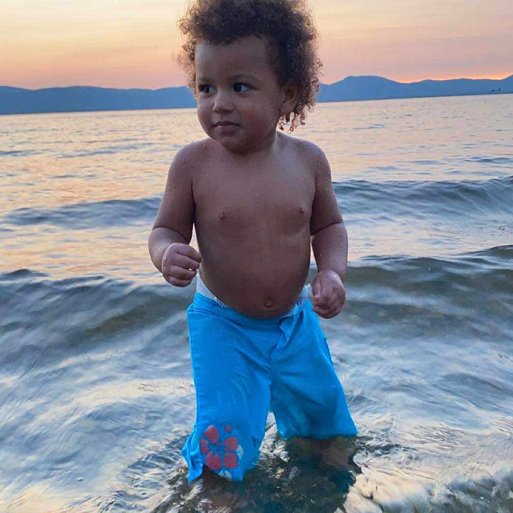 Mylo joined the competition — help win amazing prizes! baby, beach, clothing, coast, face, hair, head, horizon, nature, outdoors, pants, person, photography, portrait, sea, shoreline, shorts, sky, summer, water