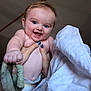 Knox is registered to the contest to win money with this photo: baby, background_ceiling, blanket, blue_eyes, child, closeup, cute, diaper, face, fingernails, hand, happy, holding, indoor, infant, person, skin, smiling, soft_texture, towel