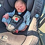 newborn, baby, car_seat, gray, infant, child, seatbelt, sitting, outdoor, sunlight, expression, face, clothing, sleepsuit, safety, transport, head_support, tiny, cute, portrait