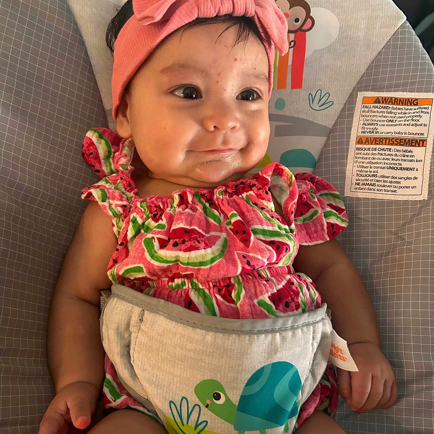 Henesey joined the competition — help win amazing prizes! animal_illustration, baby, baby_seat, child, clothing, colorful, cute, face, hand, headband, indoor, infant, legs, pink_bow, portrait, safety_warning, seat, smile, sun_illustration, watermelon_pattern