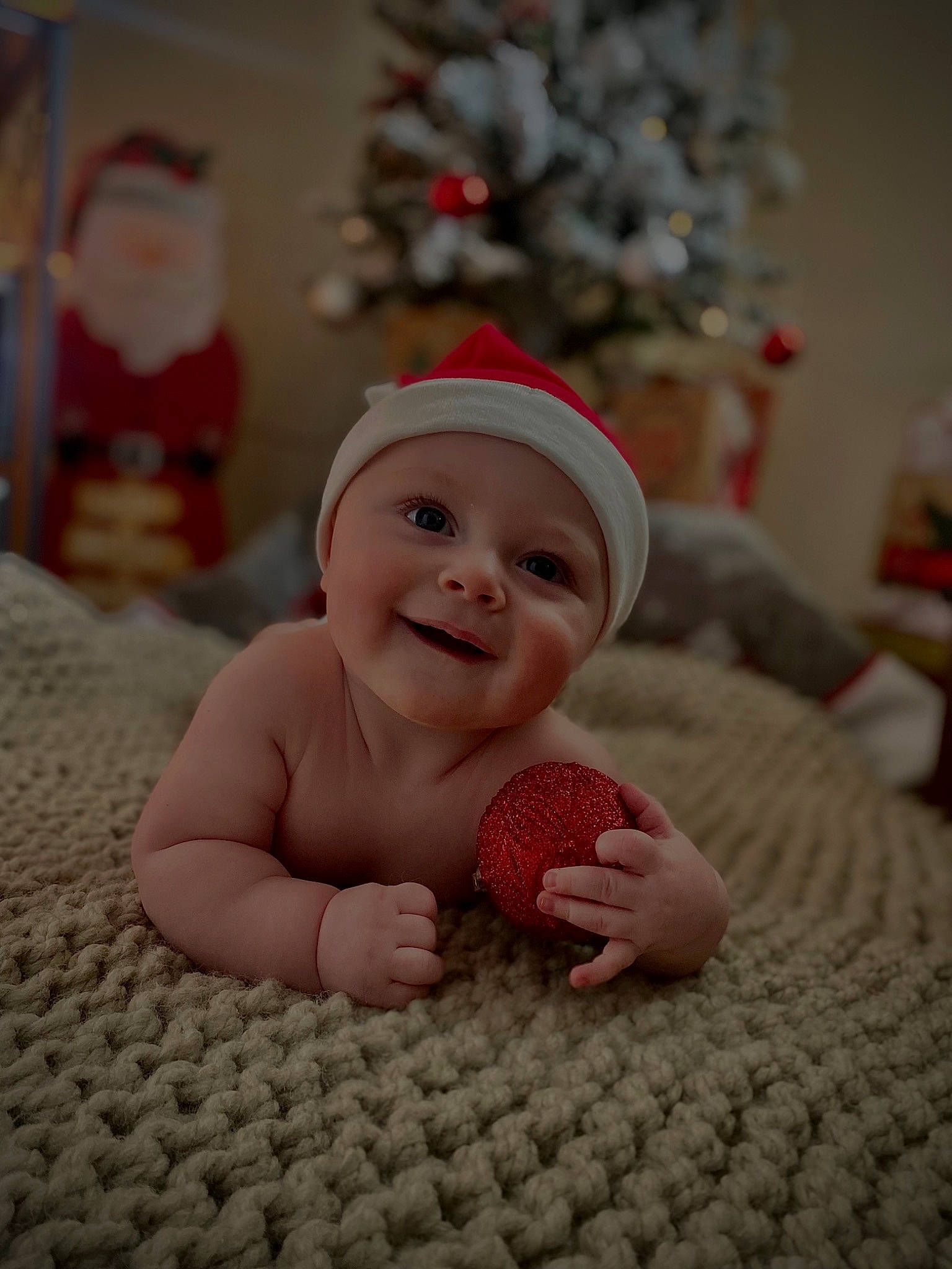 Jesse joined the competition — help win amazing prizes! baby, baby_toddler_clothing, carmine, child, christmas, christmas_decoration, christmas_tree, comfort, event, flooring, fun, happy, headwear, holiday, joy, linens, person, room, sitting, smile