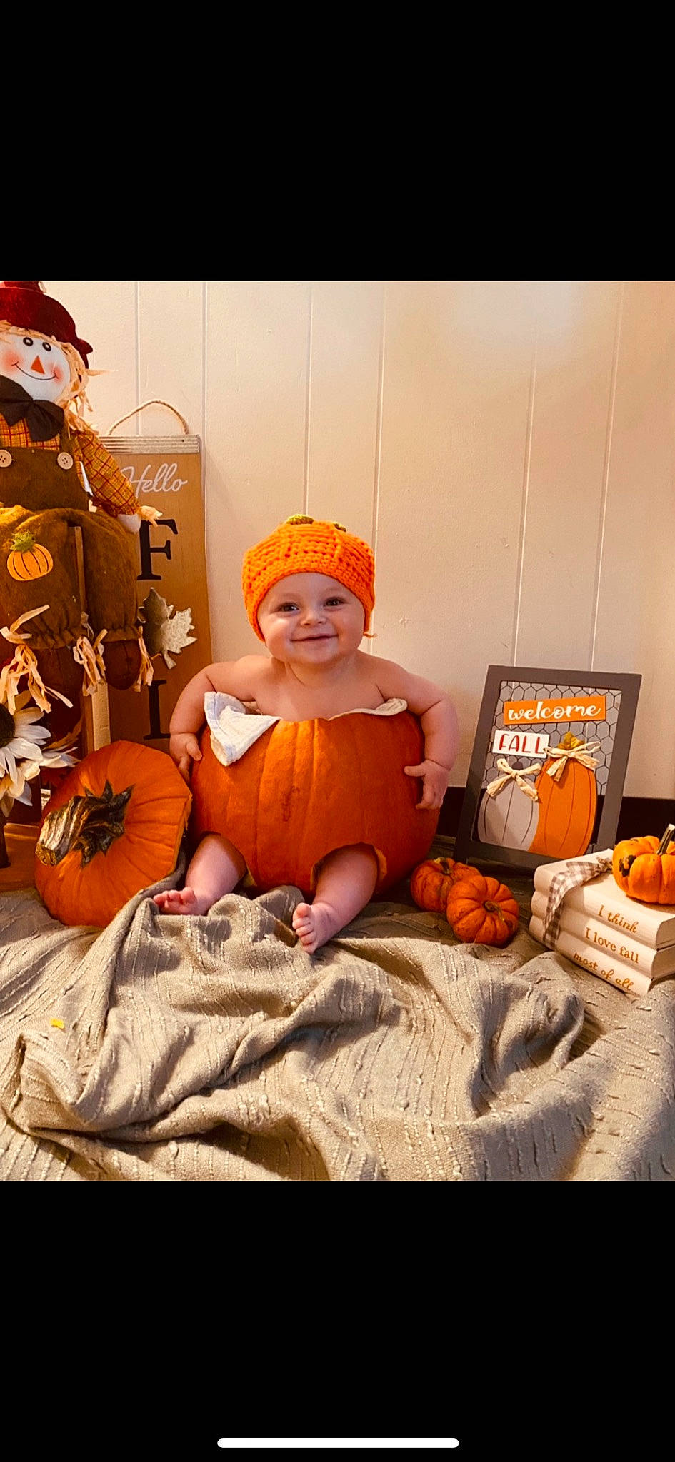 Jesse is registered to the contest to win money with this photo: calabaza, child, cucurbita, event, gourd, happy, hat, headwear, joy, local_food, natural_foods, orange, person, plant, pumpkin, room, sitting, smile, squash, toddler