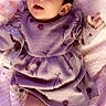 Imari is registered to the contest to win money with this photo: baby, infant, child, portrait, lying_down, lavender_clothing, dress, ruffles, socks, blanket, pink, pacifier, happy, eyes_open, open_mouth, waving, indoor, cozy, close_up, photography