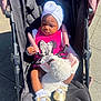 Gemma is registered to the contest to win money with this photo: accessories, baby, baseballcap, bonnet, cap, clothing, face, footwear, furniture, hat, head, person, photography, portrait, sandal, shoe, sleeping, sneaker, stroller, sunglasses