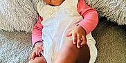 Gemma is registered to the contest to win money with this photo: baby, babylaughing, blanket, clothing, cushion, dress, face, furniture, hair, happy, head, homedecor, person, photography, portrait, quilt, shorts, sitting, sleeve, smile