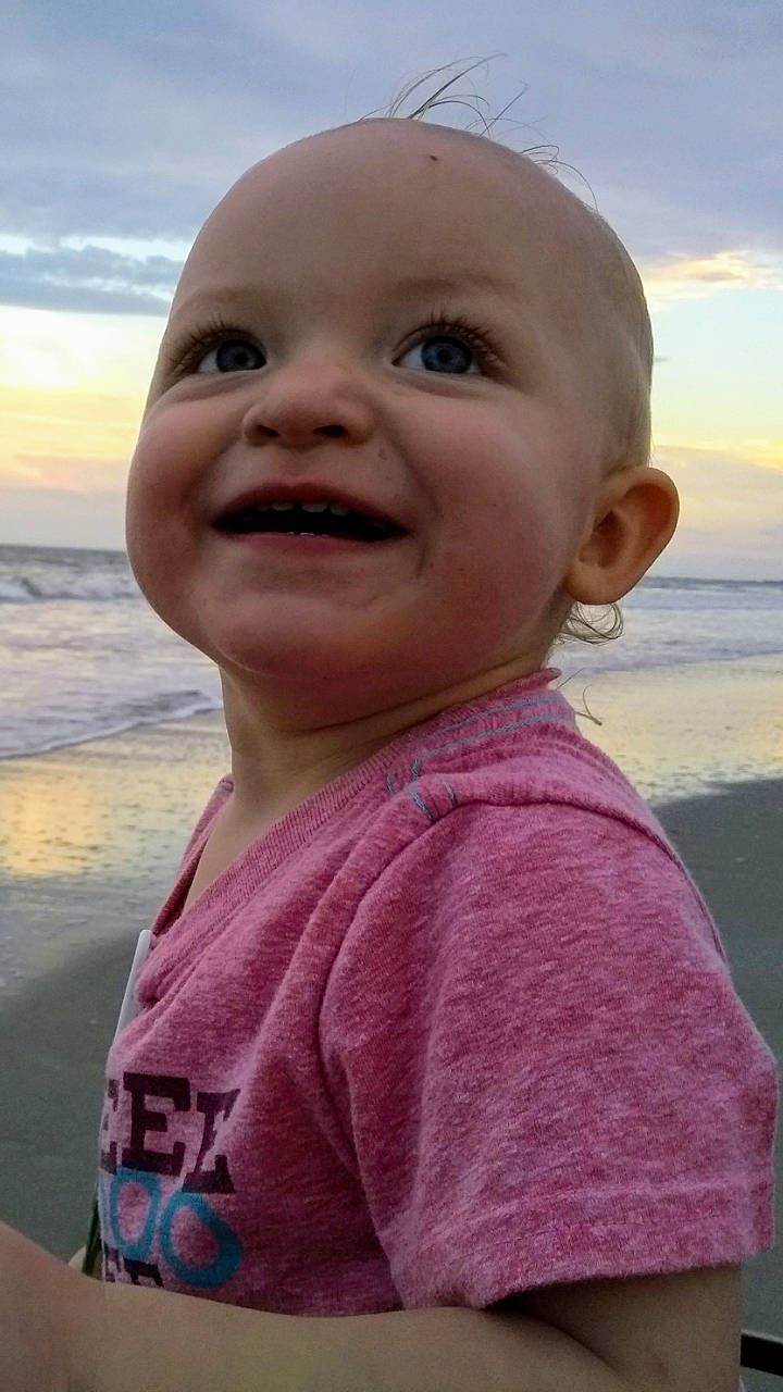 Mac is registered to the contest to win money with this photo: baby, cheek, child, chin, face, facial_expression, forehead, happy, head, laugh, nose, person, pink, skin, smile, summer, toddler, vacation