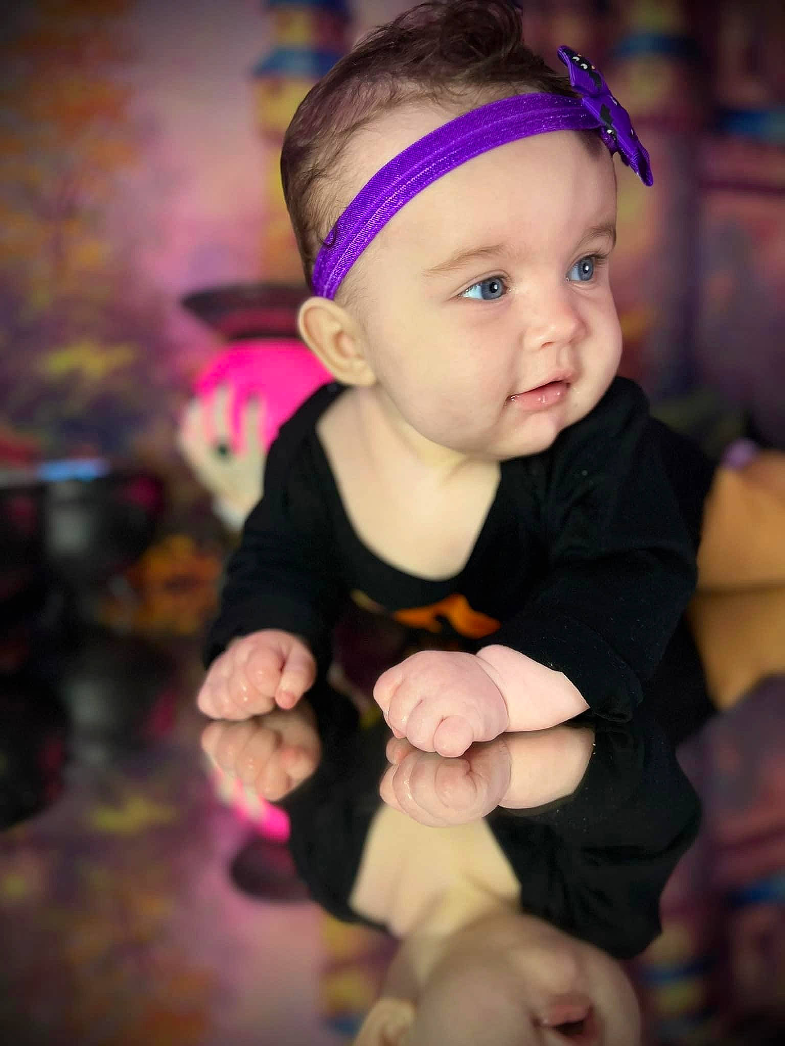 Bella is registered to the contest to win money with this photo: baby, baby_toddler_clothing, cheek, child, costume_hat, event, face, fashion_accessory, flash_photography, fun, happy, hat, head, headband, headwear, magenta, person, pink, skin, thumb