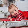 Swann a rejoint le concours — aidez-le/la à gagner de superbes lots ! baby, child, red_sweater, snowflake_pattern, sled, smiling, holiday, winter, teddy_bear, toy, festive, indoor, portrait, cute, cozy, blurred_background, smile, face, happy, lying_down