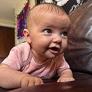 Violet joined the competition — help win amazing prizes! baby, infant, face, skin, arm, clothing, couch, leather, indoor, expression, curious, person, child, toddler, closeup, pink, smile, hand, young, portrait