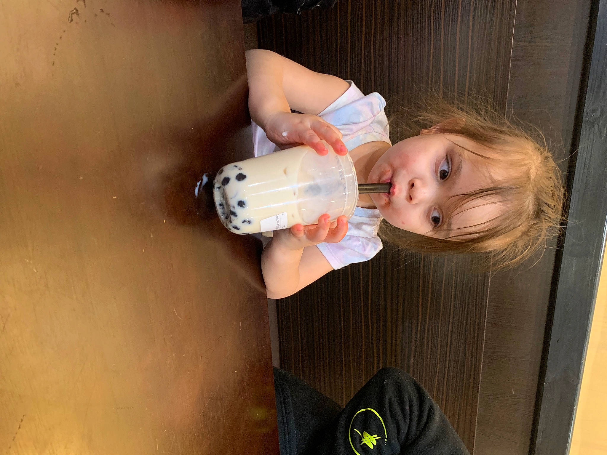 Jayliana is registered to the contest to win money with this photo: baby, chest, child, drink, drinking, drinkware, elbow, eyelash, flash_photography, human_leg, knee, lip, nail, person, plastic_bottle, skin, thumb, toddler, water, wood