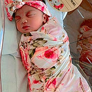 Calani is registered to the contest to win money with this photo: newborn, baby, infant, sleeping, swaddled, floral, pink, headband, hospital, bassinet, blanket, face, person, cute, resting, peaceful, birth_announcement, wooden_plaque, decorations, koala