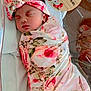 newborn, baby, infant, sleeping, swaddled, floral, pink, headband, hospital, bassinet, blanket, face, person, cute, resting, peaceful, birth_announcement, wooden_plaque, decorations, koala