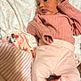 baby, blanket, child, cozy, cute, cute_expression, fabric, indoors, infant, lying_down, minnie_mouse, newborn, pink_clothing, portrait, pout, resting, sleepwear, small_hands, soft_texture, striped_socks
