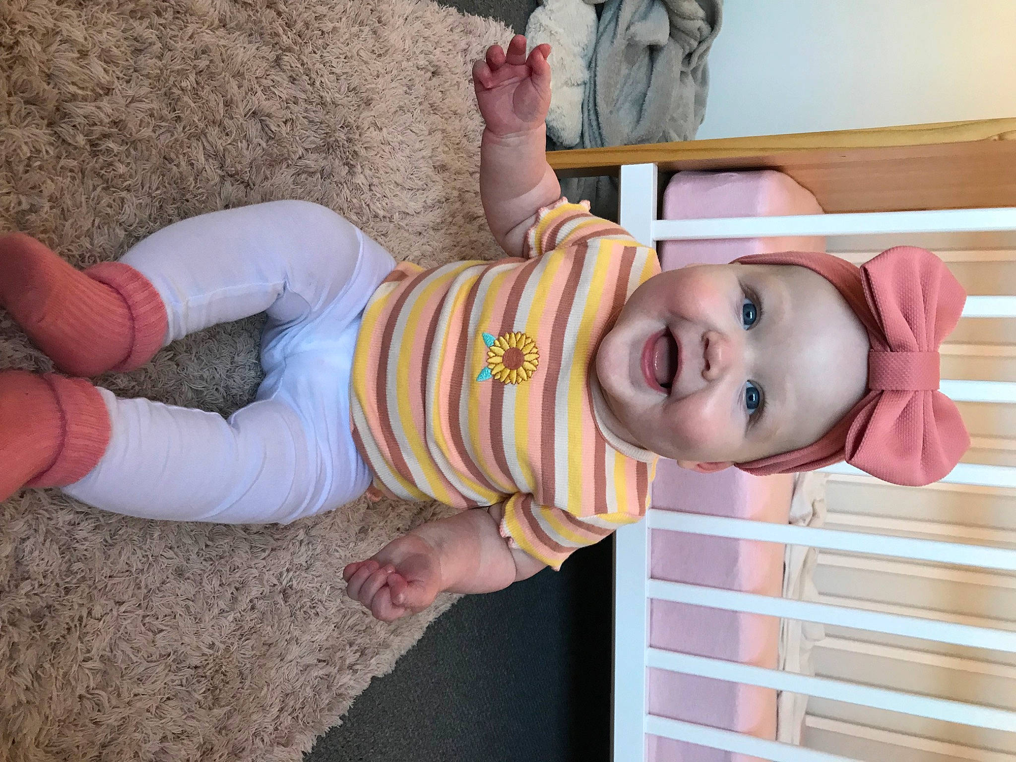 Isobel is registered to the contest to win money with this photo: arm, baby, baby_toddler_clothing, clothing, dress, eye, finger, hand, happy, hat, joint, leg, nose, person, pink, skin, sleeve, smile, thumb, toddler