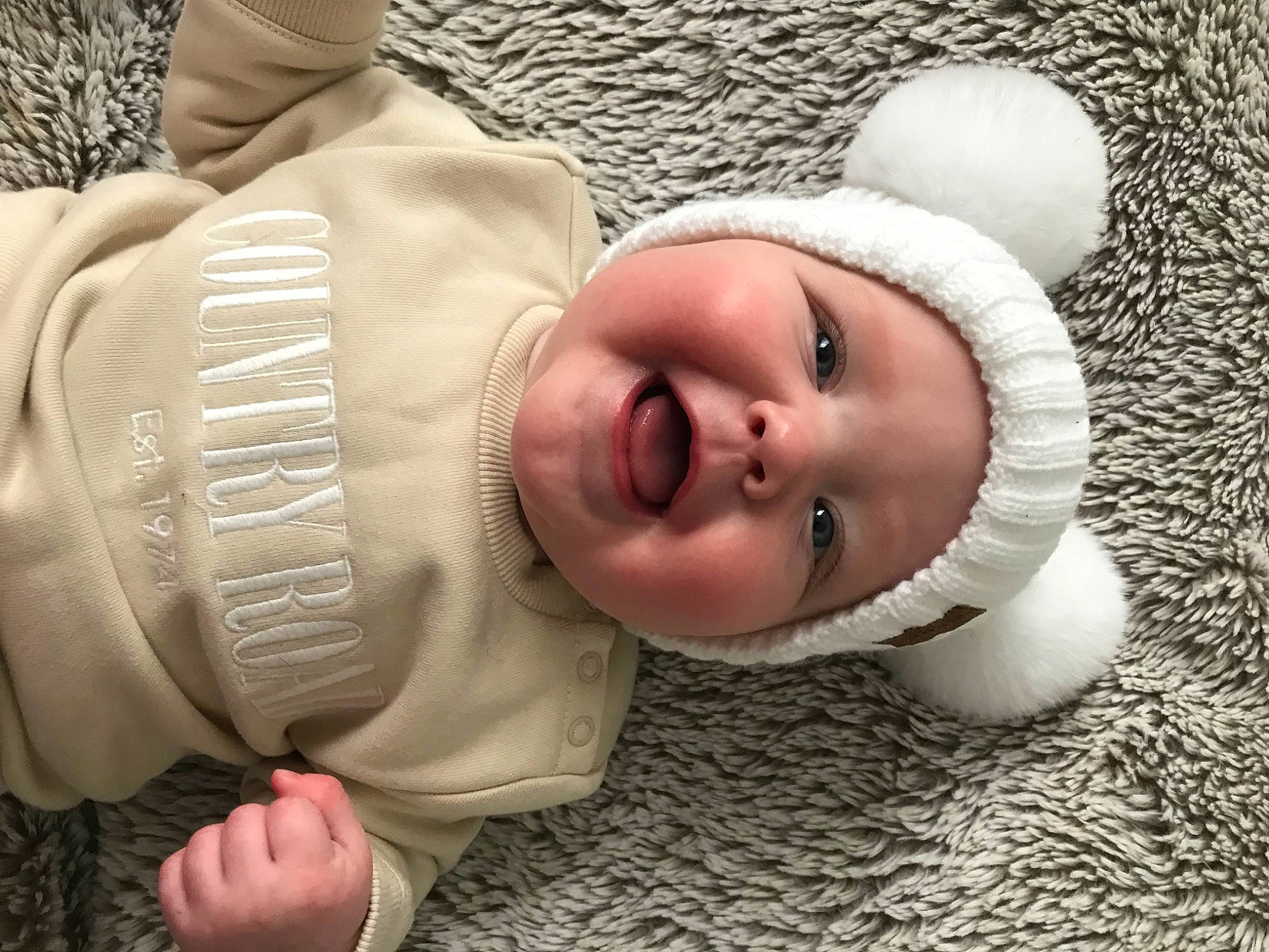 Isobel is registered to the contest to win money with this photo: baby, baby_toddler_clothing, cap, cheek, chin, comfort, cool, eye, face, finger, flash_photography, hand, happy, head, headwear, lip, mouth, nose, person, skin