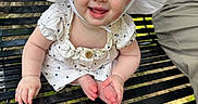 Harley joined the competition — help win amazing prizes! baby, child, smiling, white_hat, polka_dot_dress, bench, outdoor, grass, happy, person, face, headwear, summer, cute, sitting, portrait, daylight, skin, arm, legs