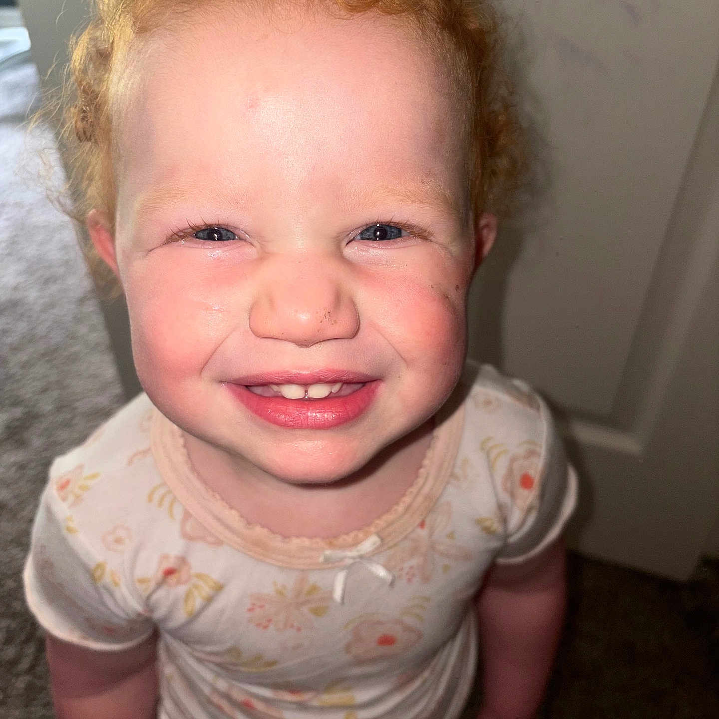 Athena joined the competition — help win amazing prizes! baby, carpet, cheerful, child, closeup, curly_hair, cute, face, front_view, happy, human, indoor, onesie, person, portrait, red_hair, smiling, standing, toddler, young_child