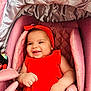 baby, baby_accessories, baby_clothing, bracelet, child, closeup, comfort, cute, face, hand, happy, headband, infant, infant_girl, pink_stroller, portrait, red_dress, seat, skin, smiling