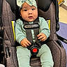 baby, child, car_seat, seatbelt, headwrap, bow, clothing, infant, cute, indoors, person, sitting, smile, socks, happy, face, young_child, secured, comfortable, portrait