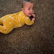 Aliyah is registered to the contest to win money with this photo: baby, brown_carpet, carpet, child, childrens_clothing, curious_expression, cute, face, floor, floral_pattern, head, indoors, infant, lying_down, person, portrait, small_hands, tummy_time, yellow_onesie, young_child
