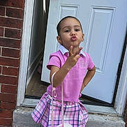 Aliany joined the competition — help win amazing prizes! child, girl, pink_shirt, plaid_skirt, unicorn_purse, pink_shoes, white_socks, door, brick_wall, sidewalk, concrete, pose, playful, outdoor, fashion, cute, person, young, standing, accessory