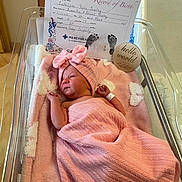 Lakelynn Rylie is registered to the contest to win money with this photo: newborn, baby, infant, hospital, bassinet, pink_blanket, swaddle, bow_headband, sleeping, face, portrait, birth_certificate, footprints, hello_world_sign, medical_bracelet, hospital_room, blanket, crib, new_arrival, family_milestone